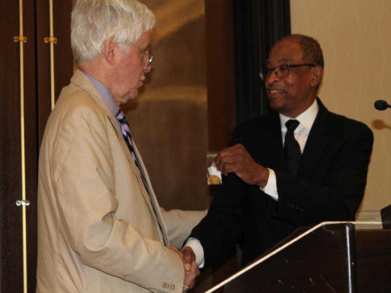 photo James Thomas handing Robert Gaffney past president pin