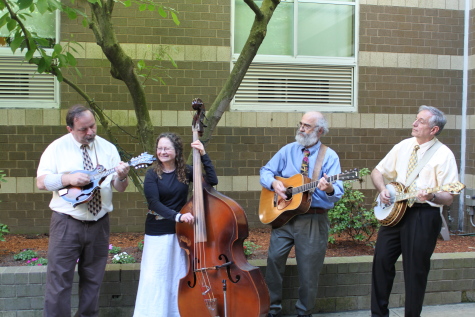 Photo of Southern Rail playing in the court yard. Featuring John Roc (left) on the mandolin.
